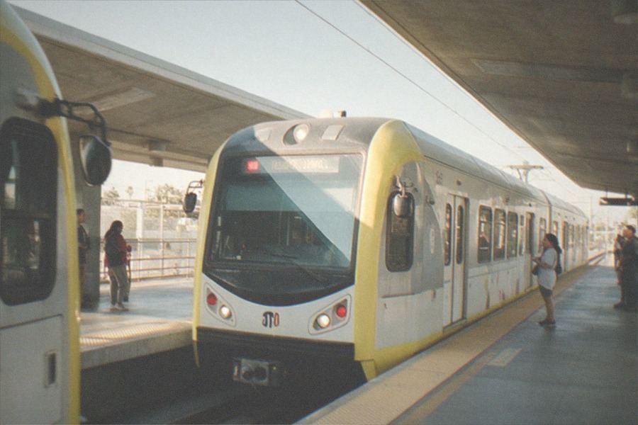 Metro light rail platform at Expo Park with the museum district visible beyond the tracks