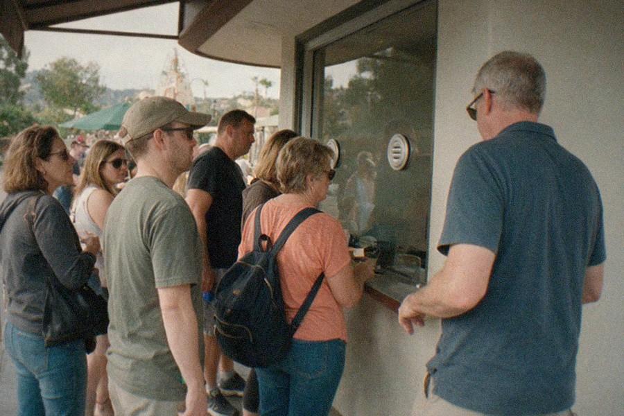 Visitors waiting at the Getty Center tram platform with the hillside garden in the background