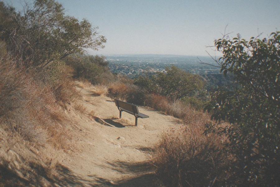 The white Art Deco dome and colonnade of Griffith Observatory on a hillside above the city