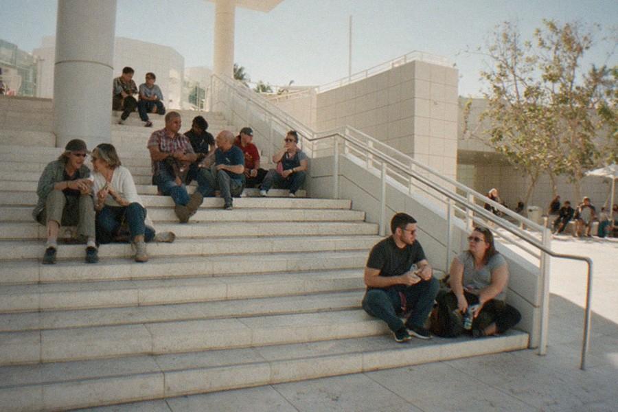Museum courtyard with travertine walls and sculpted garden under a clear sky