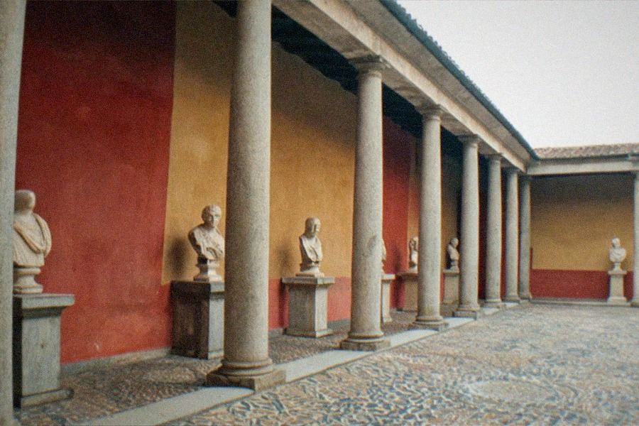 The Getty Villa's outer peristyle garden with a long reflecting pool flanked by statues and low hedges