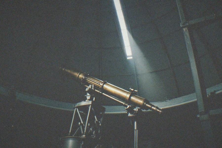 Visitors gathered on the west terrace of Griffith Observatory at dusk, with the illuminated sprawl of Los Angeles spreading toward the horizon