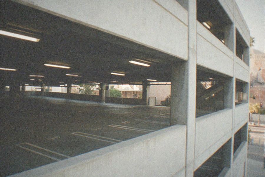 Museum parking structure with a tram station and hills in the background