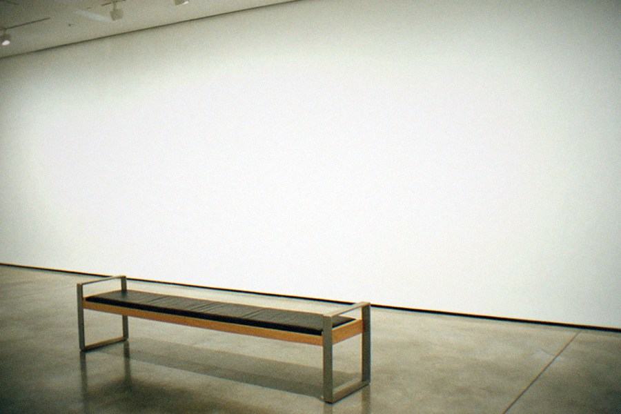 A bright museum gallery with large contemporary paintings on white walls
