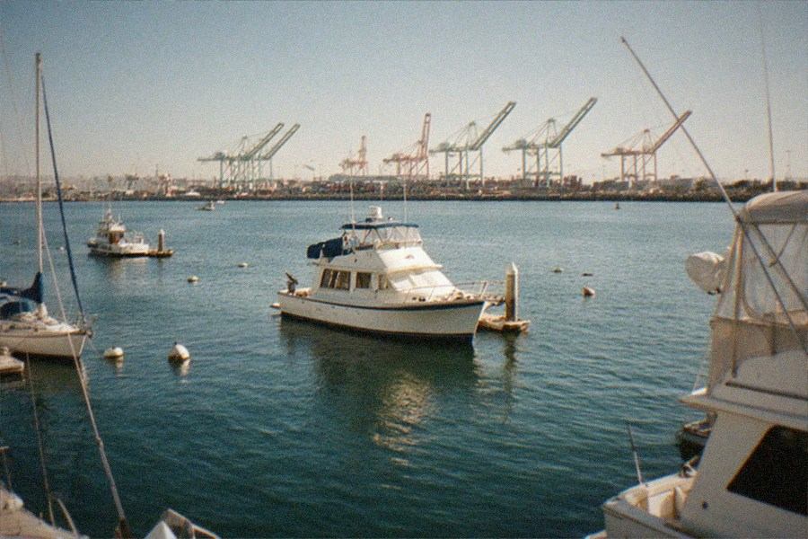 Waterfront museum building with sailboats moored along a calm harbor