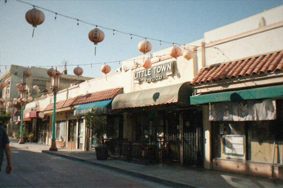 Studio backlot street with period storefronts under overcast light