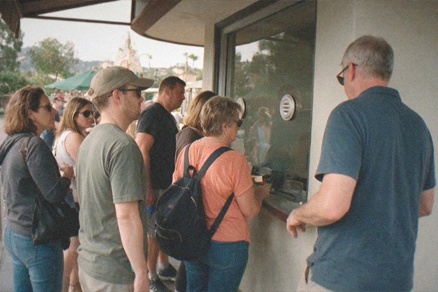 Aquarium tunnel with fish swimming overhead and visitors walking through