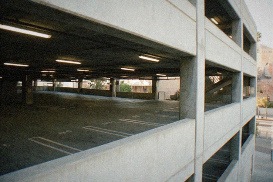 A parking structure entrance beside a museum campus in the afternoon
