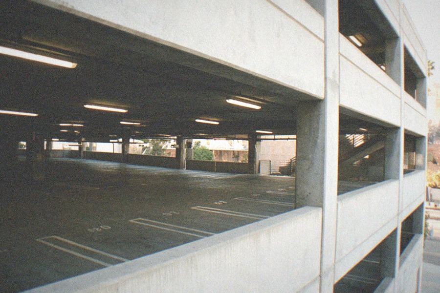 Classic cars displayed on multiple levels inside an automotive museum atrium