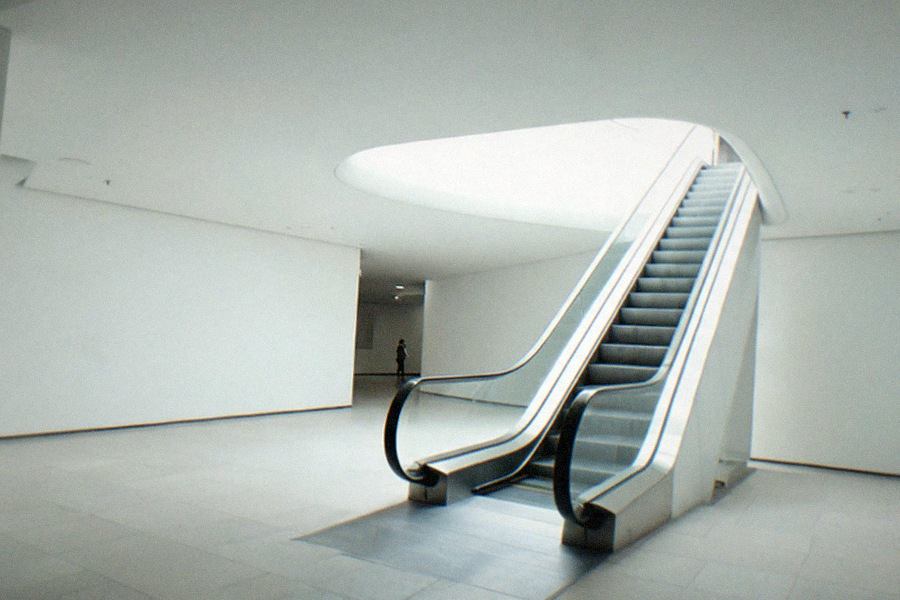 Visitors moving through a bright third-floor gallery at The Broad, daylight filtering through the honeycomb ceiling onto large contemporary paintings