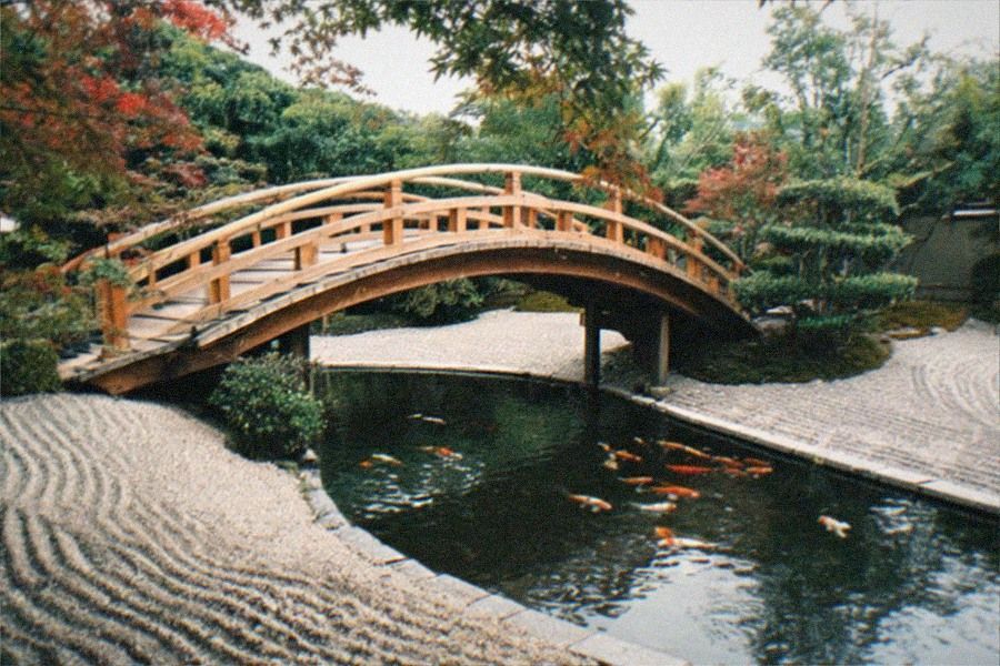 The Chinese garden at The Huntington, with a lake, stone bridge and wooden pavilion surrounded by trees